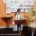 عکس اجرای سرود ملی ایران با فلوت توسط کودک دزفولی