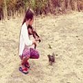 عکس Karolina protsenko is playing violin for little squirrel